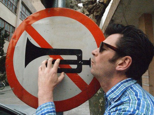 John Ingledew blowing his own trumpet (a road sign)