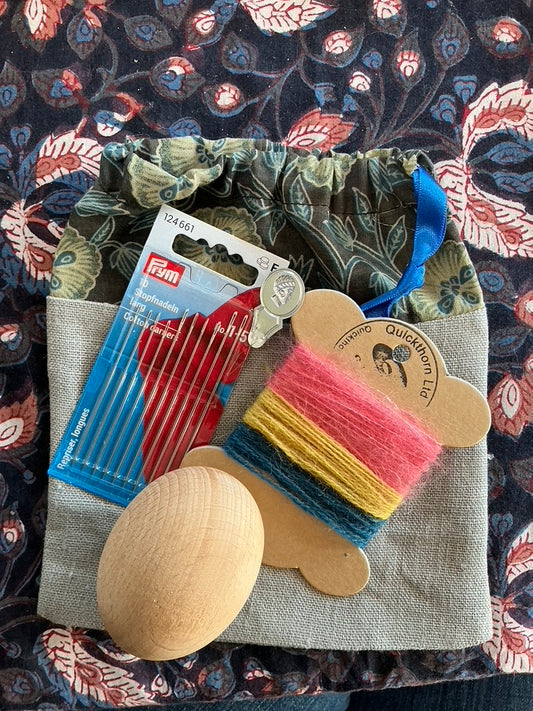 Darning kit with new darning egg, needles threader and wool yarn all in a drawstring bag